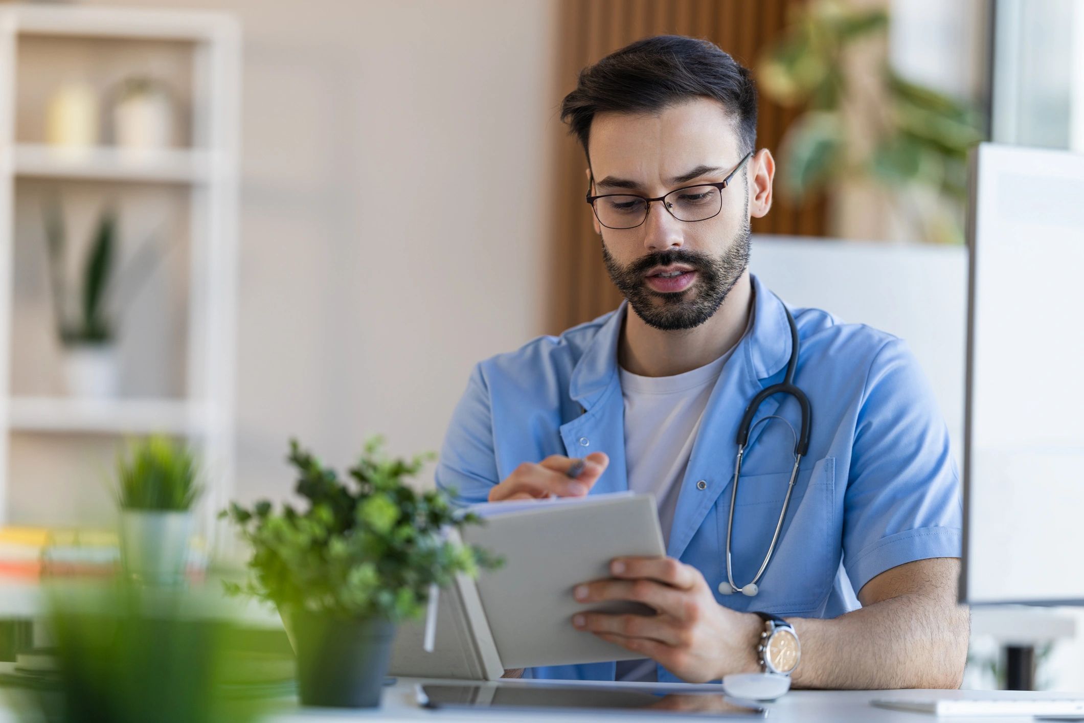 Clinician using a tablet to review records in an office